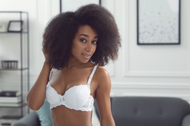 Photo of Beautiful woman in elegant white underwear indoors, space for text