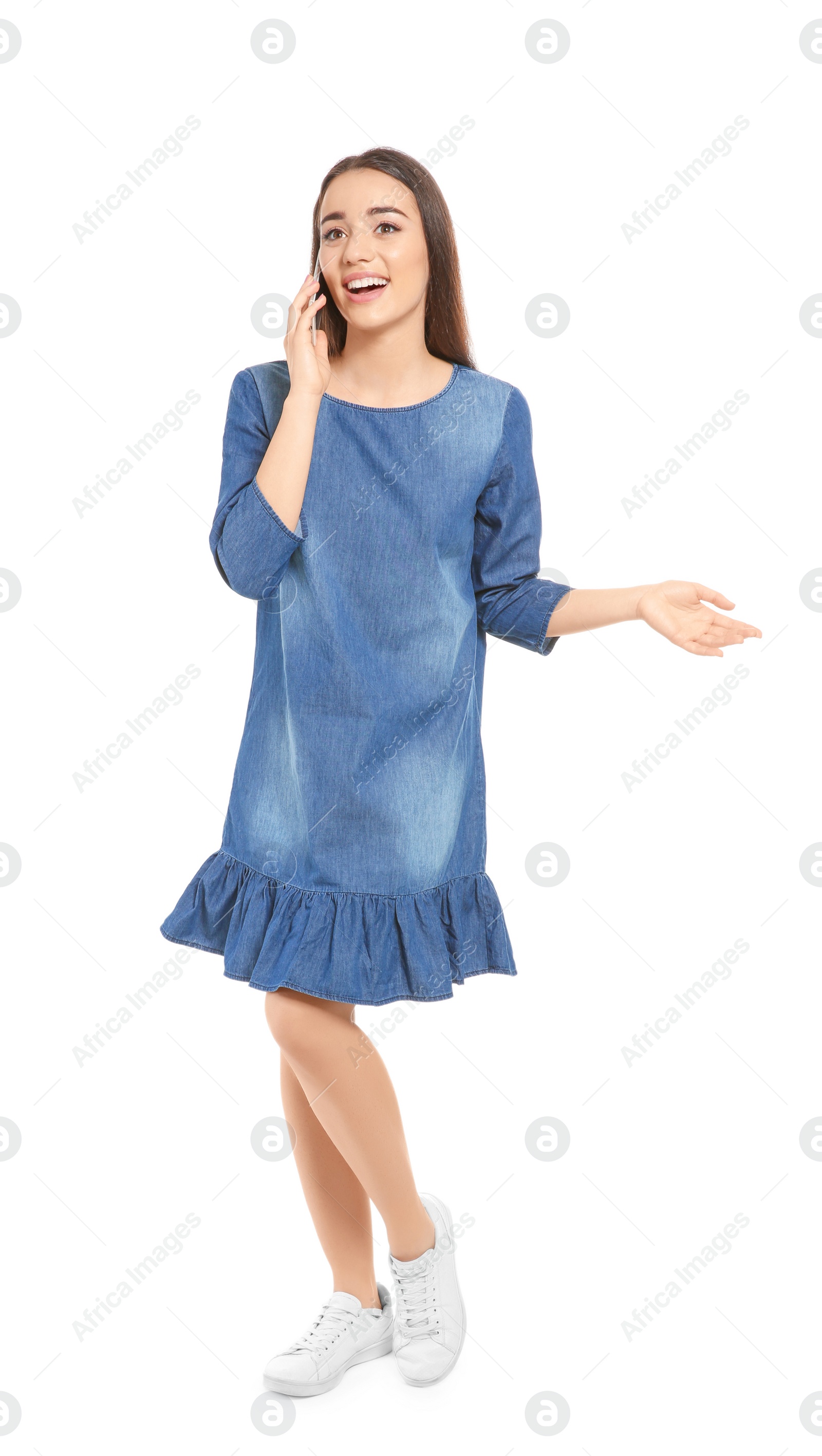 Photo of Attractive young woman talking on mobile phone against white background