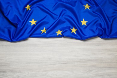 Flag of European Union on wooden table, top view. Space for text