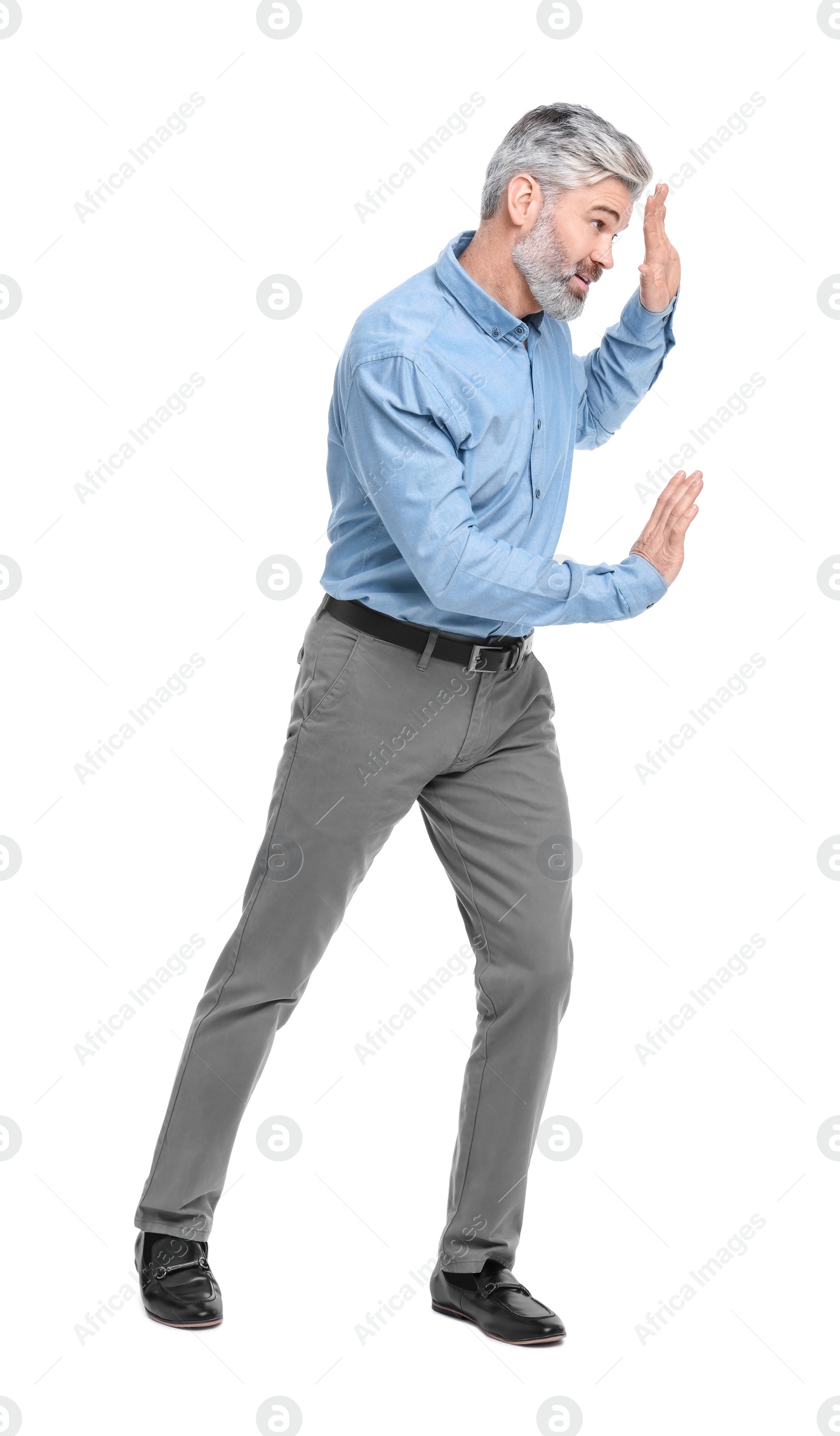 Photo of Mature businessman in stylish clothes avoiding something on white background