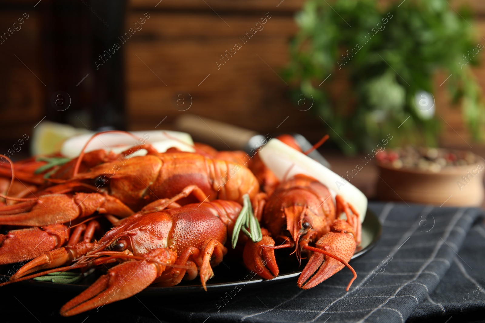 Photo of Delicious red boiled crayfishes on table, closeup