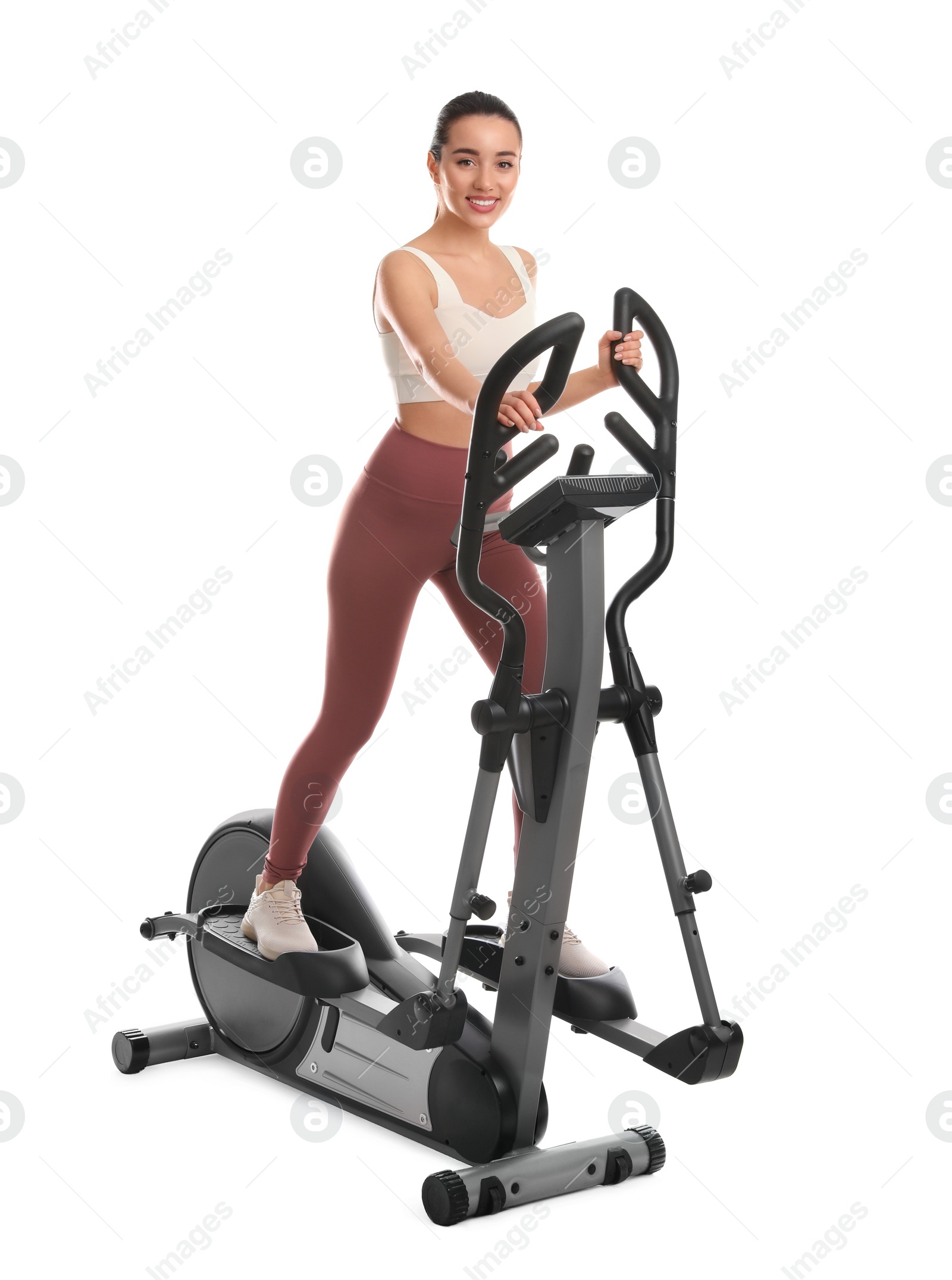 Photo of Woman using modern elliptical machine on white background