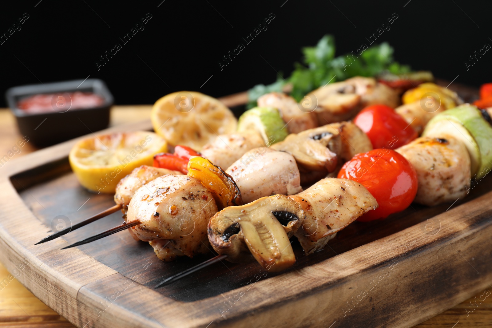 Photo of Delicious shish kebabs with grilled vegetables served on table, closeup