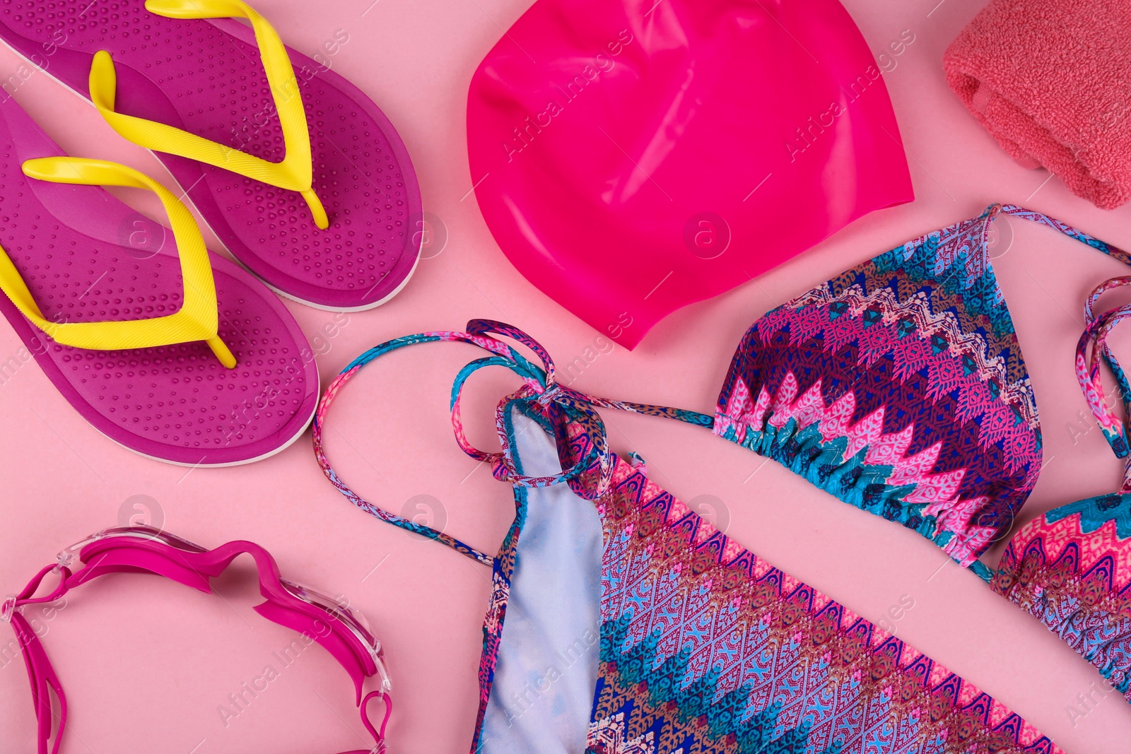 Photo of Flat lay composition with swimming accessories on pink background