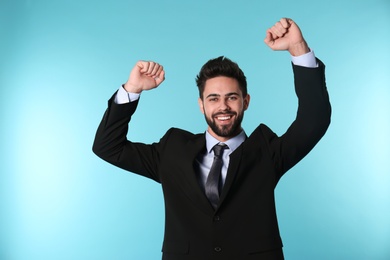 Photo of Portrait of happy young businessman on color background