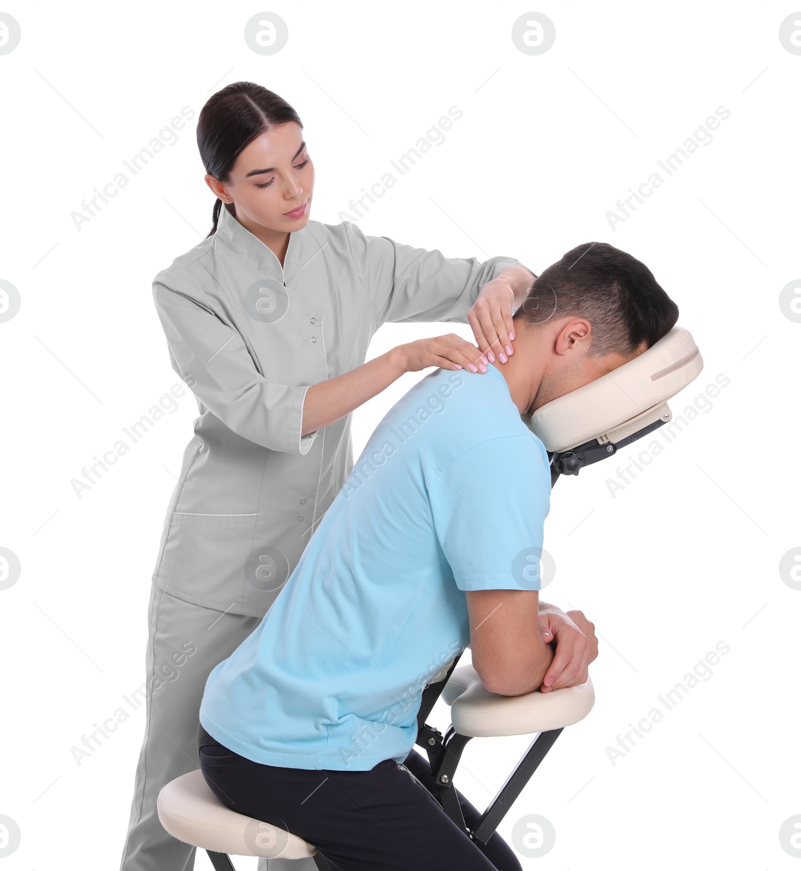 Photo of Man receiving massage in modern chair on white background