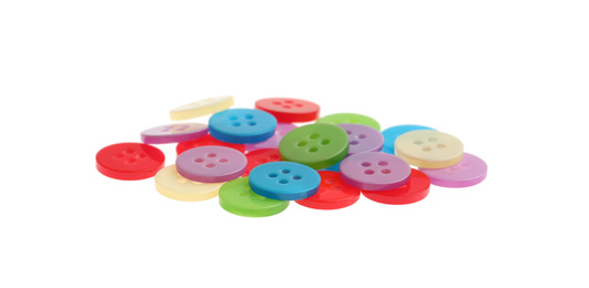 Many colorful sewing buttons on white background