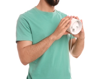 Man with portable fan on white background, closeup. Summer heat