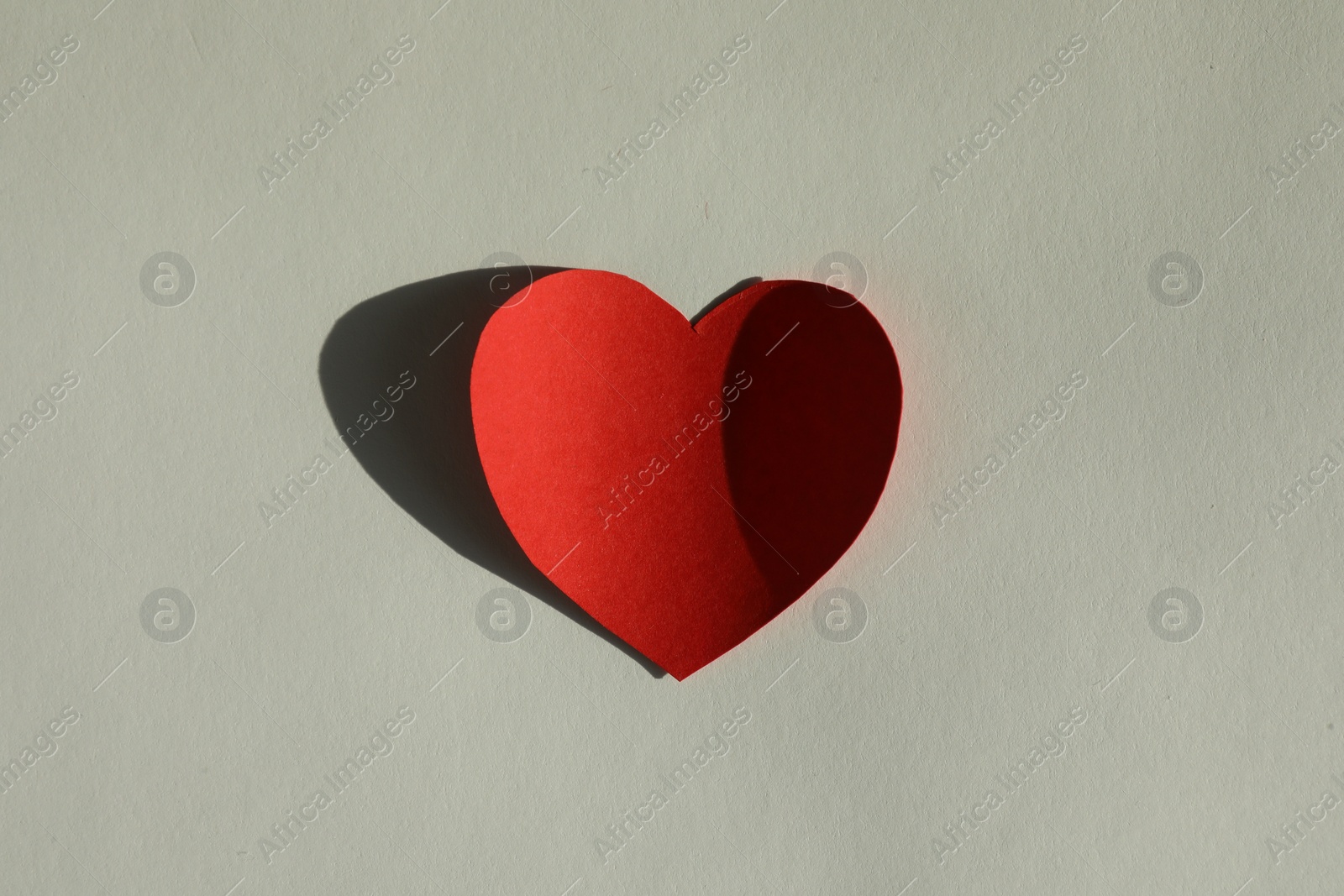 Photo of One paper heart on grey background, top view