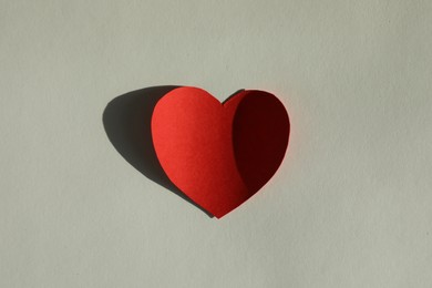 One paper heart on grey background, top view