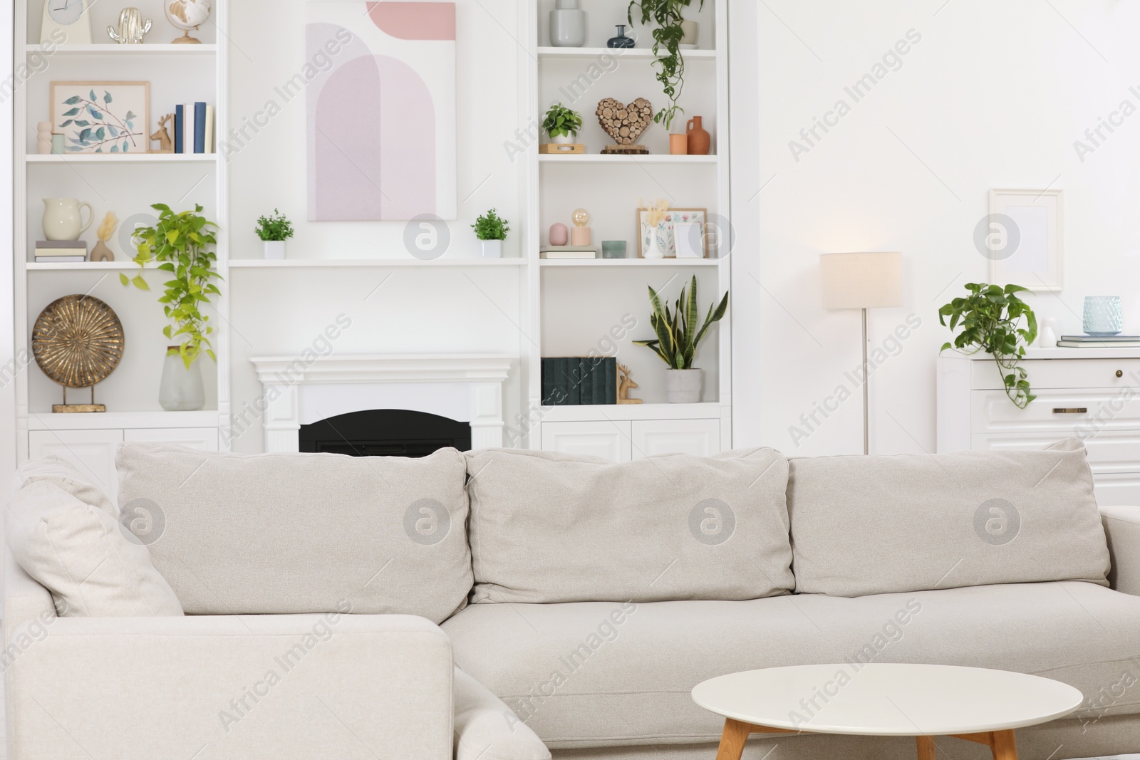 Photo of Stylish living room interior with comfortable sofa and side table