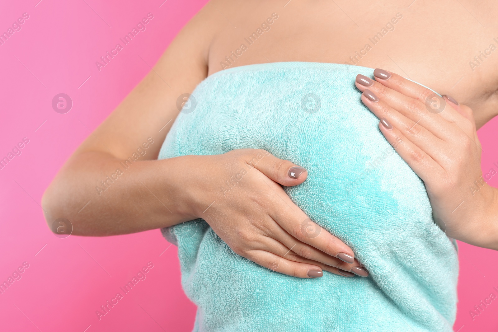 Photo of Woman checking her breast on color background, closeup