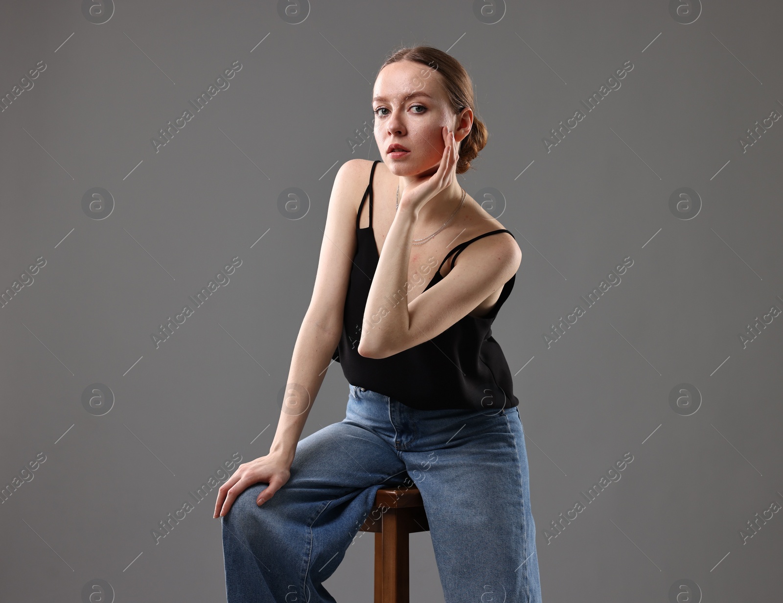 Photo of Fashionable portrait of beautiful young woman on grey background