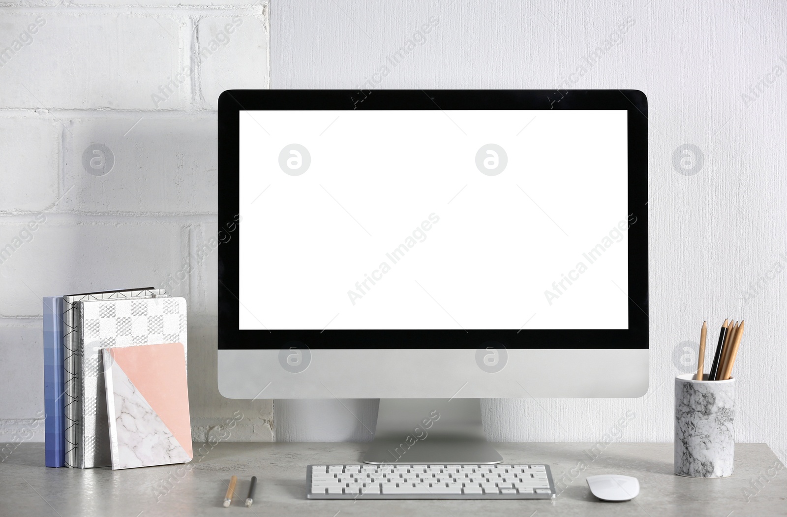 Photo of Computer with blank monitor on office table. Mock up for design