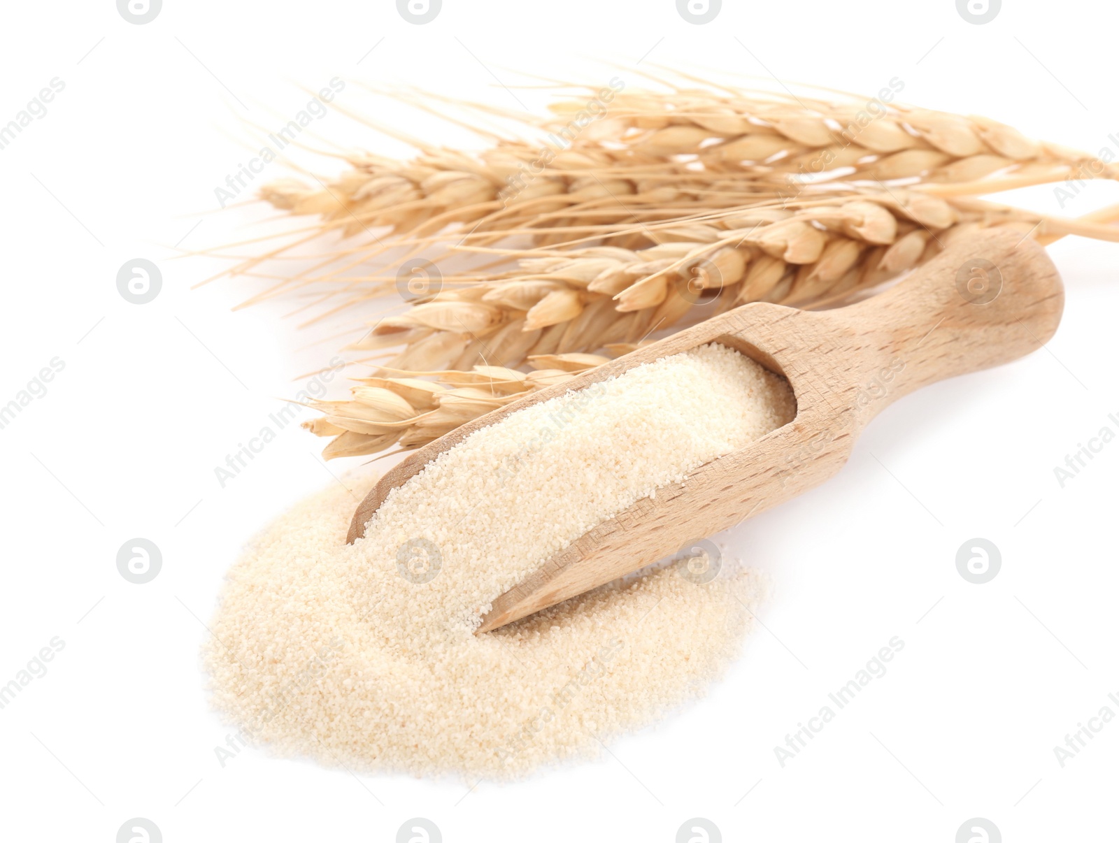 Photo of Scoop with semolina and spikelets on white background