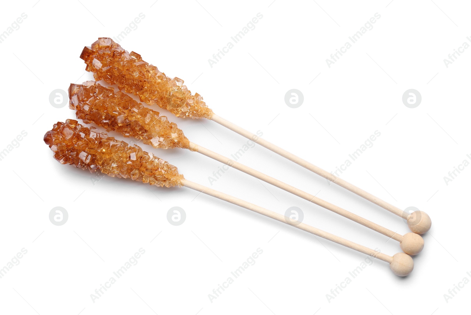 Photo of Wooden sticks with sugar crystals isolated on white, top view. Tasty rock candies