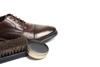 Stylish men's footwear and shoe care accessories on white background, closeup