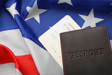 Passport and ticket on flag of USA