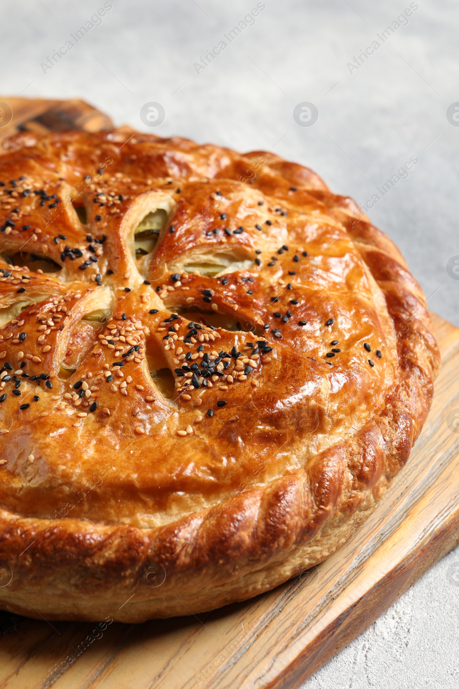 Photo of Tasty homemade pie with filling on light grey table