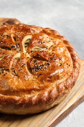 Photo of Tasty homemade pie with filling on light grey table