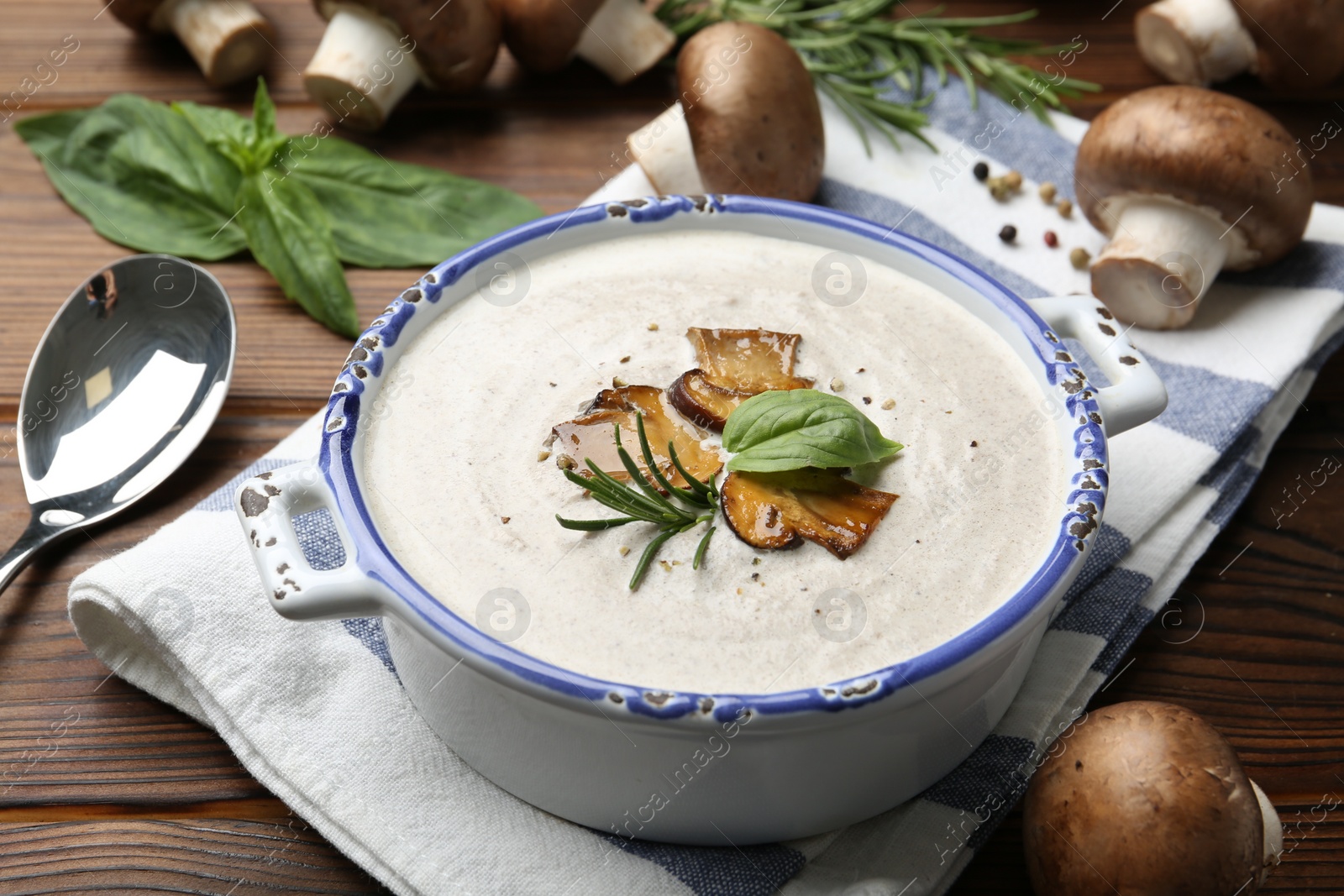 Photo of Delicious homemade mushroom soup served on wooden table