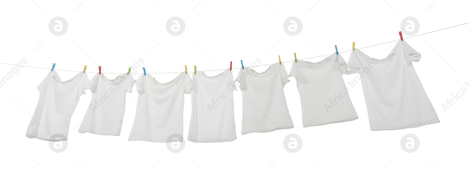 Photo of Many t-shirts drying on washing line isolated on white