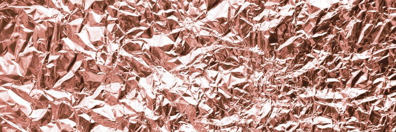 Image of Crumpled rose gold foil as background, closeup. Banner design
