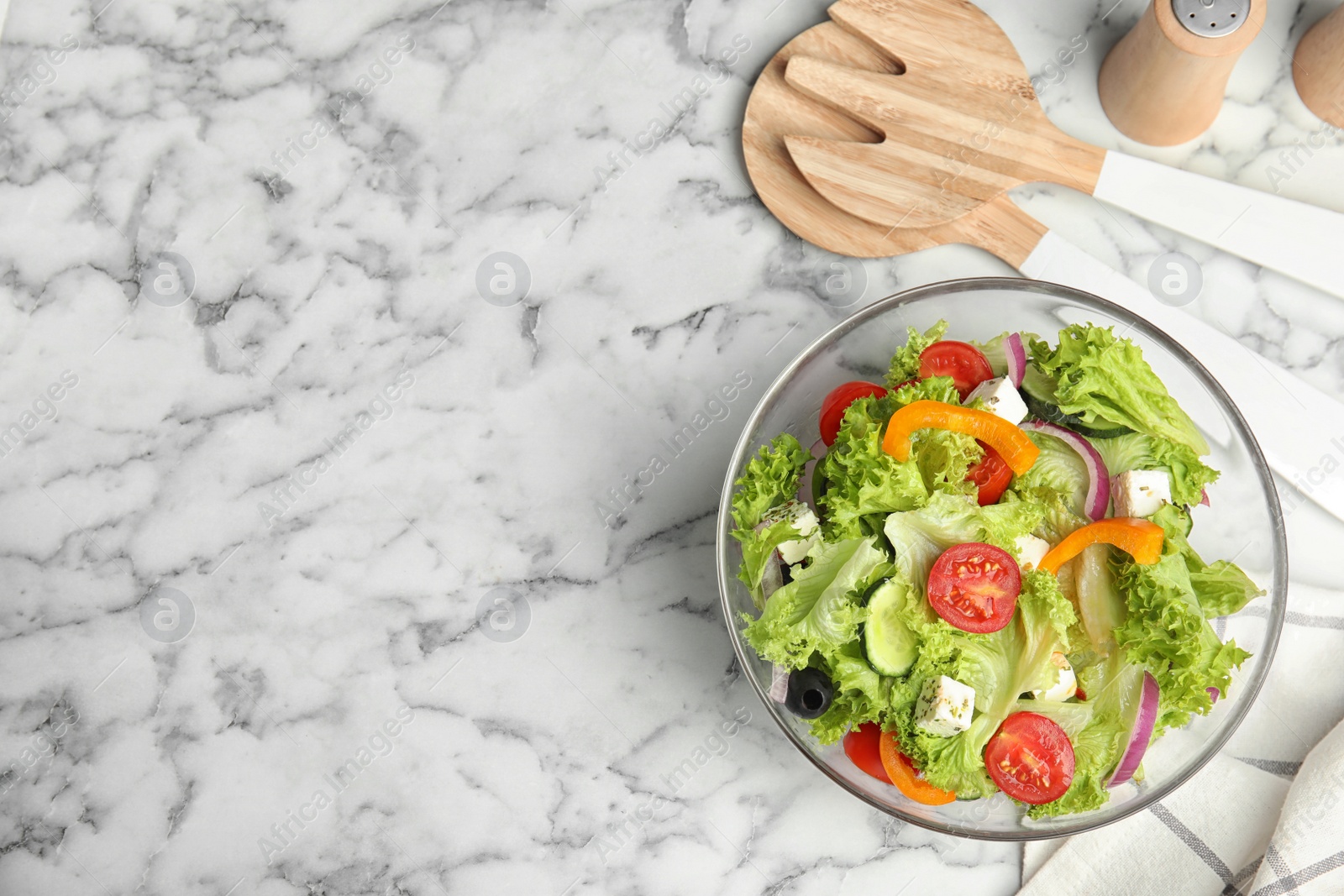 Photo of Tasty fresh Greek salad on white marble table, flat lay. Space for text