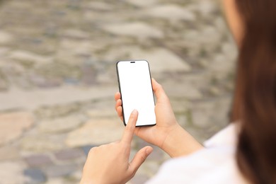 Closeup view of woman using smartphone outdoors