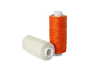 Photo of Different colorful sewing threads on white background