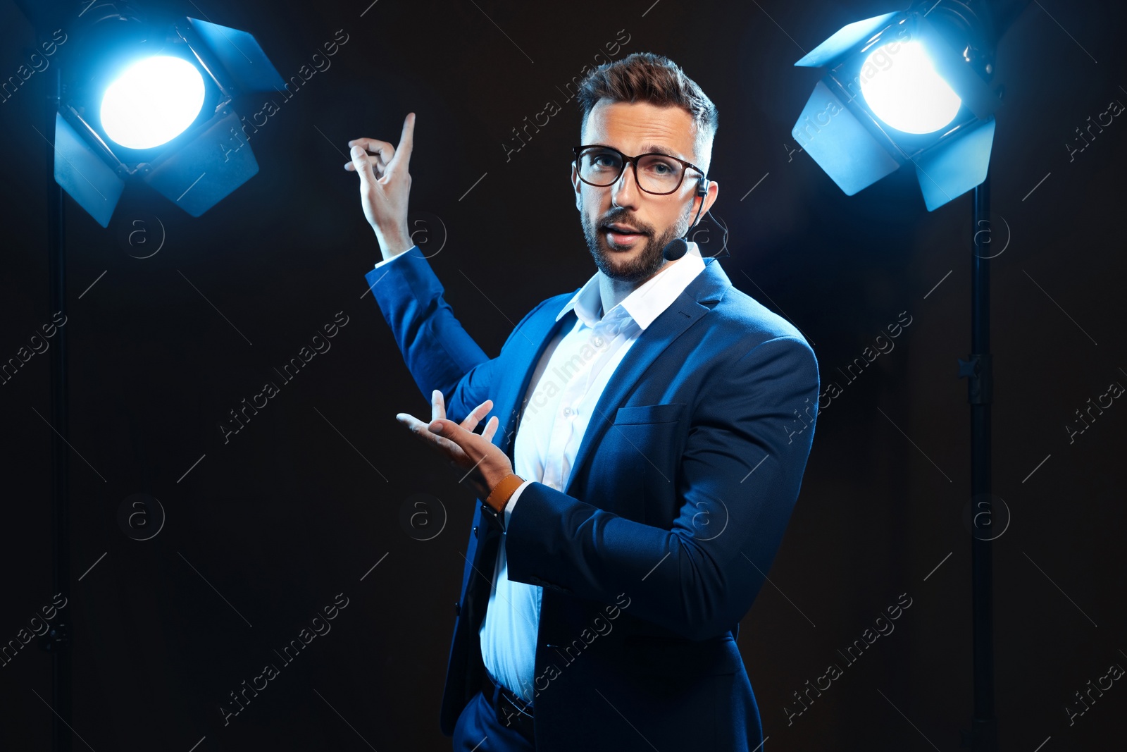 Photo of Motivational speaker with headset performing on stage