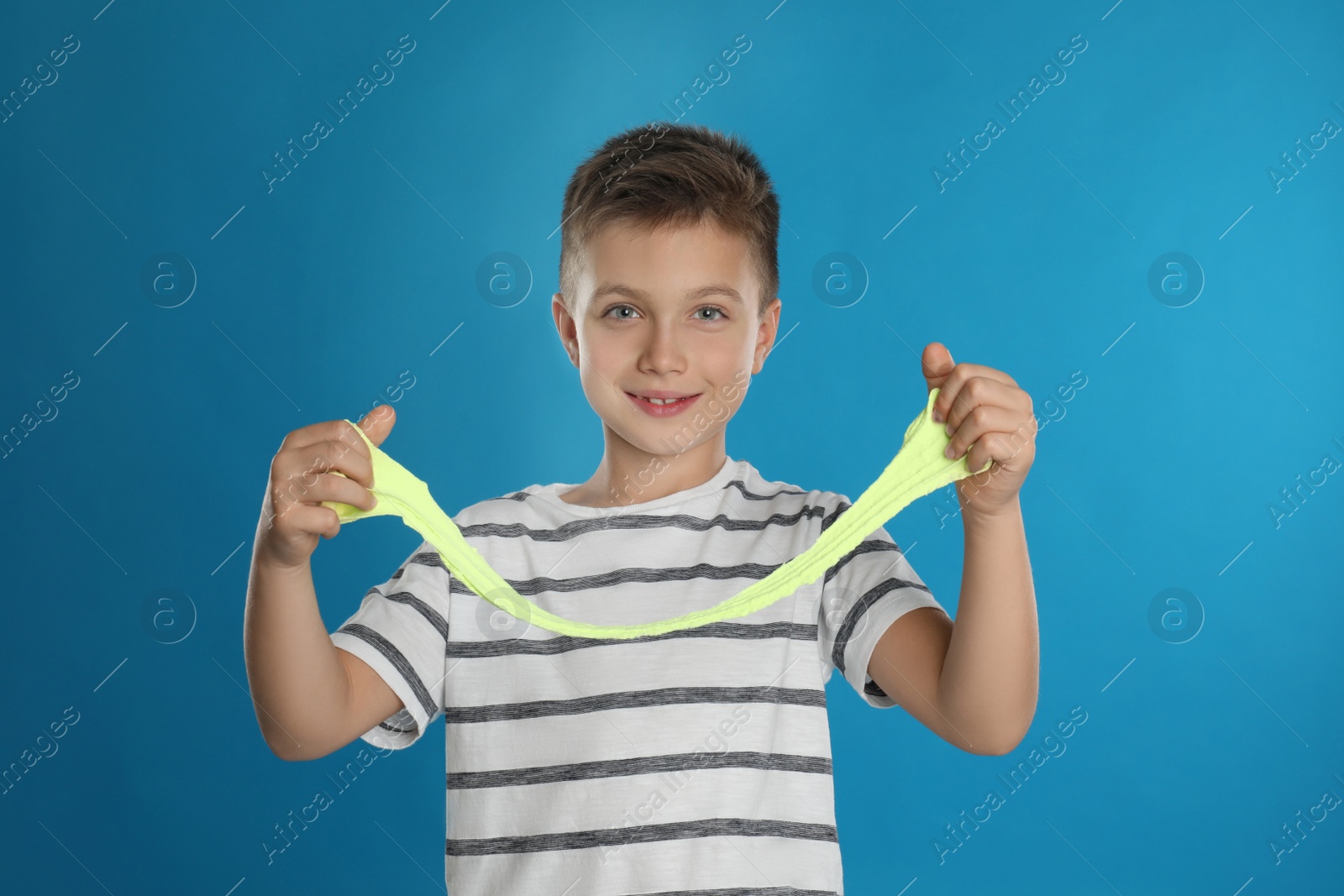 Photo of Little boy with slime on blue background