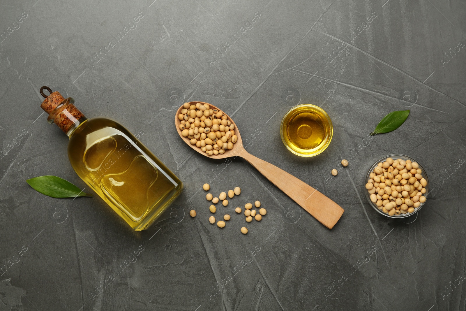 Photo of Flat lay composition with soybean oil on grey table