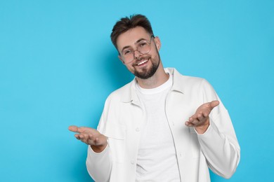 Photo of Handsome man in white jacket on light blue background