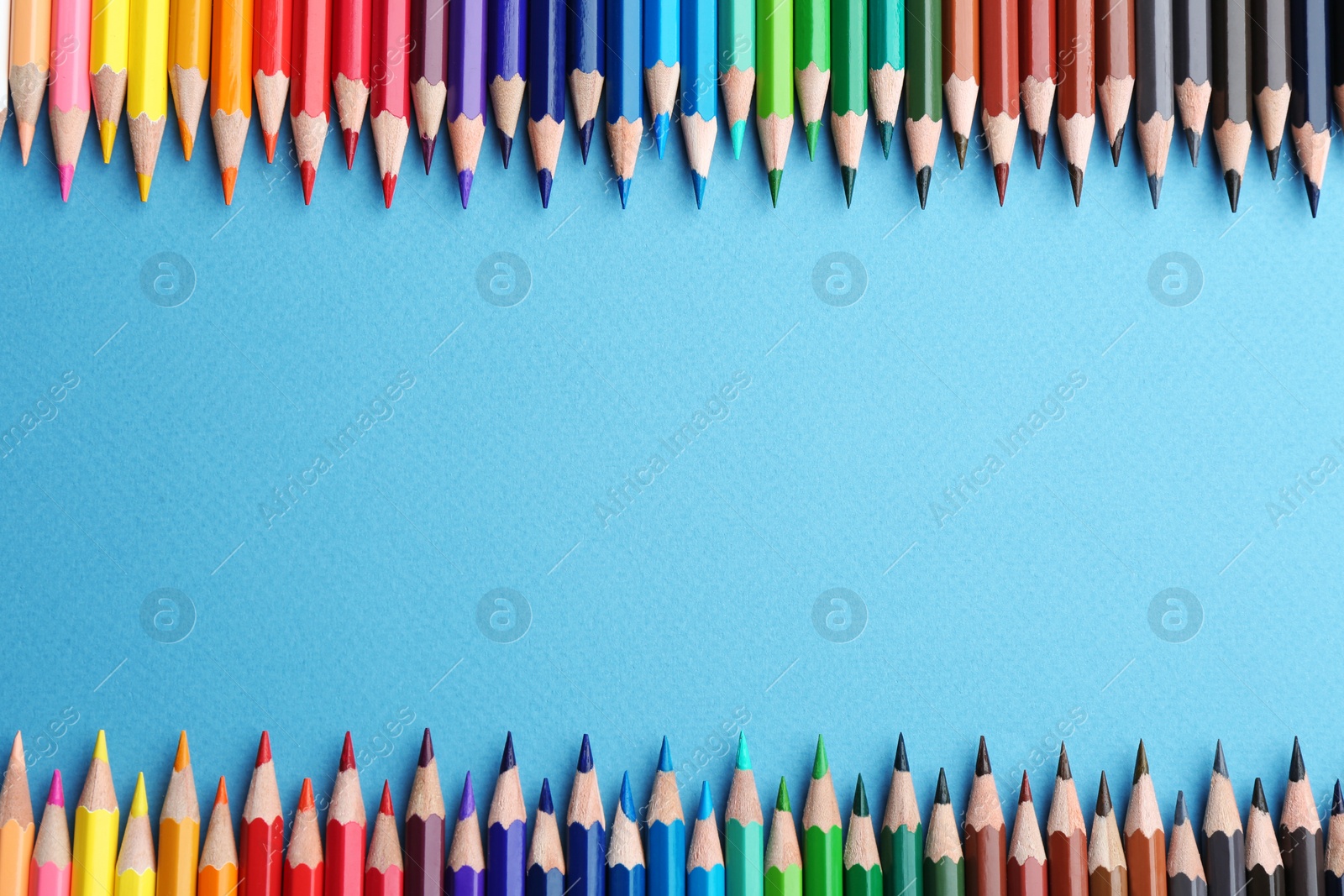 Photo of Flat lay composition with color pencils on blue background. Space for text