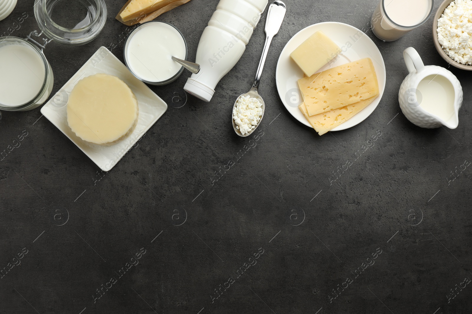 Photo of Many different lactose free dairy products on grey textured table, flat lay. Space for text