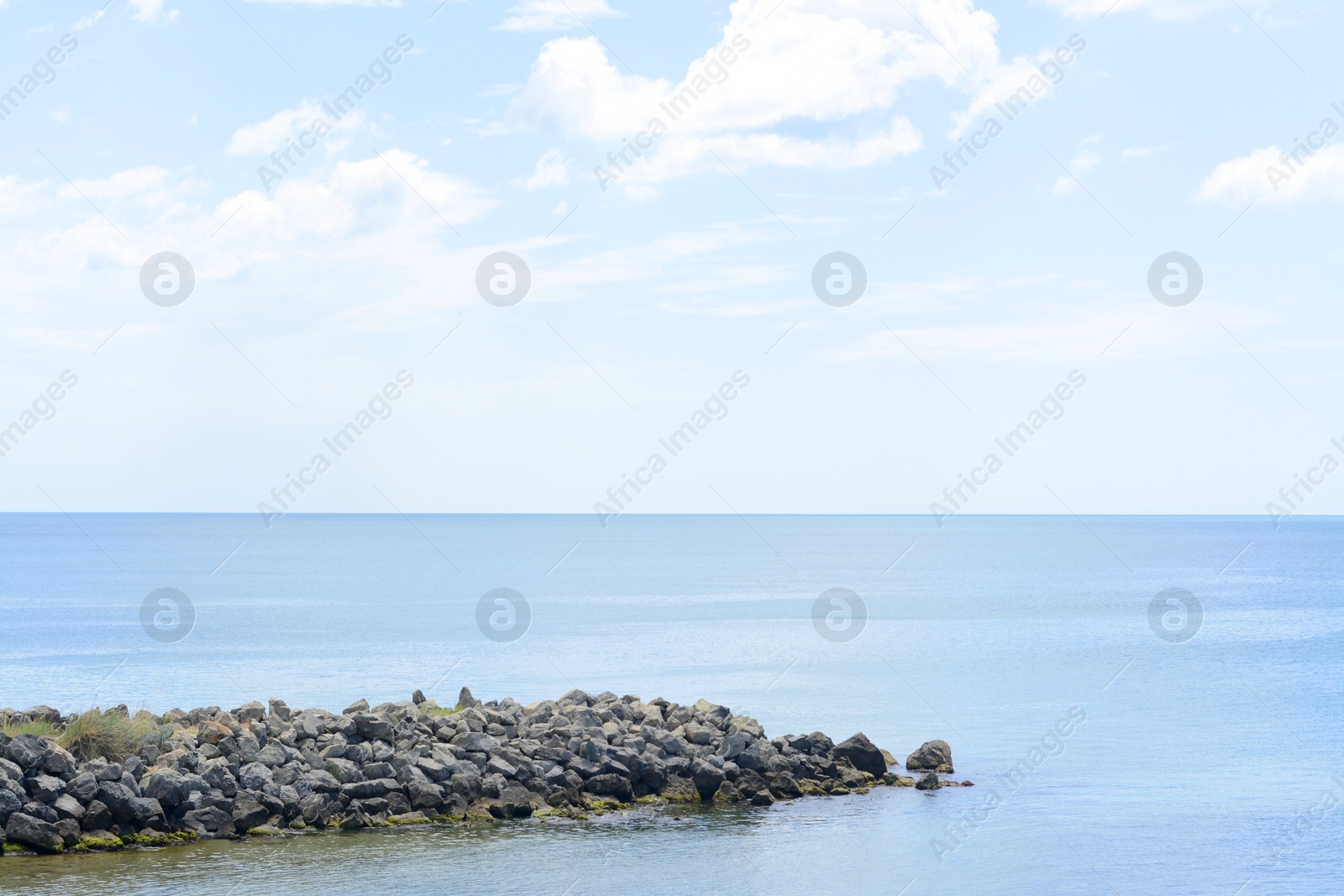 Photo of Picturesque view of beautiful seascape with stone coast on cloudy day
