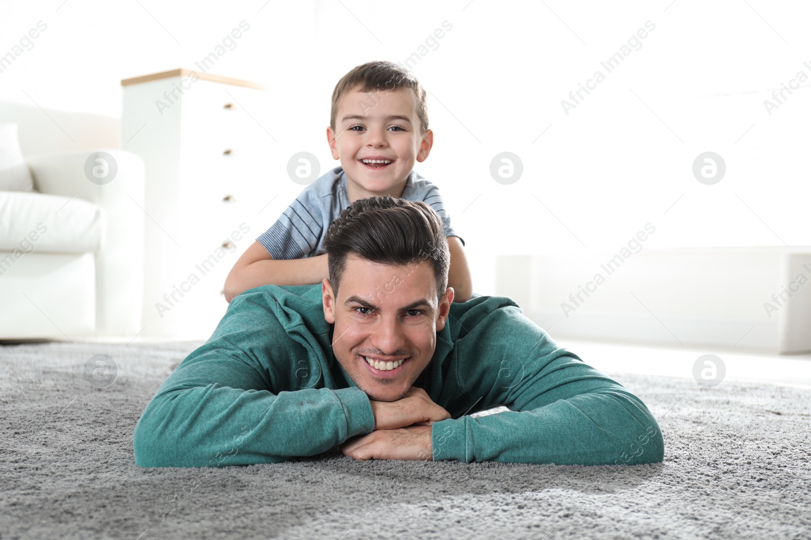 Photo of Dad and son spending time together at home. Happy Father's Day