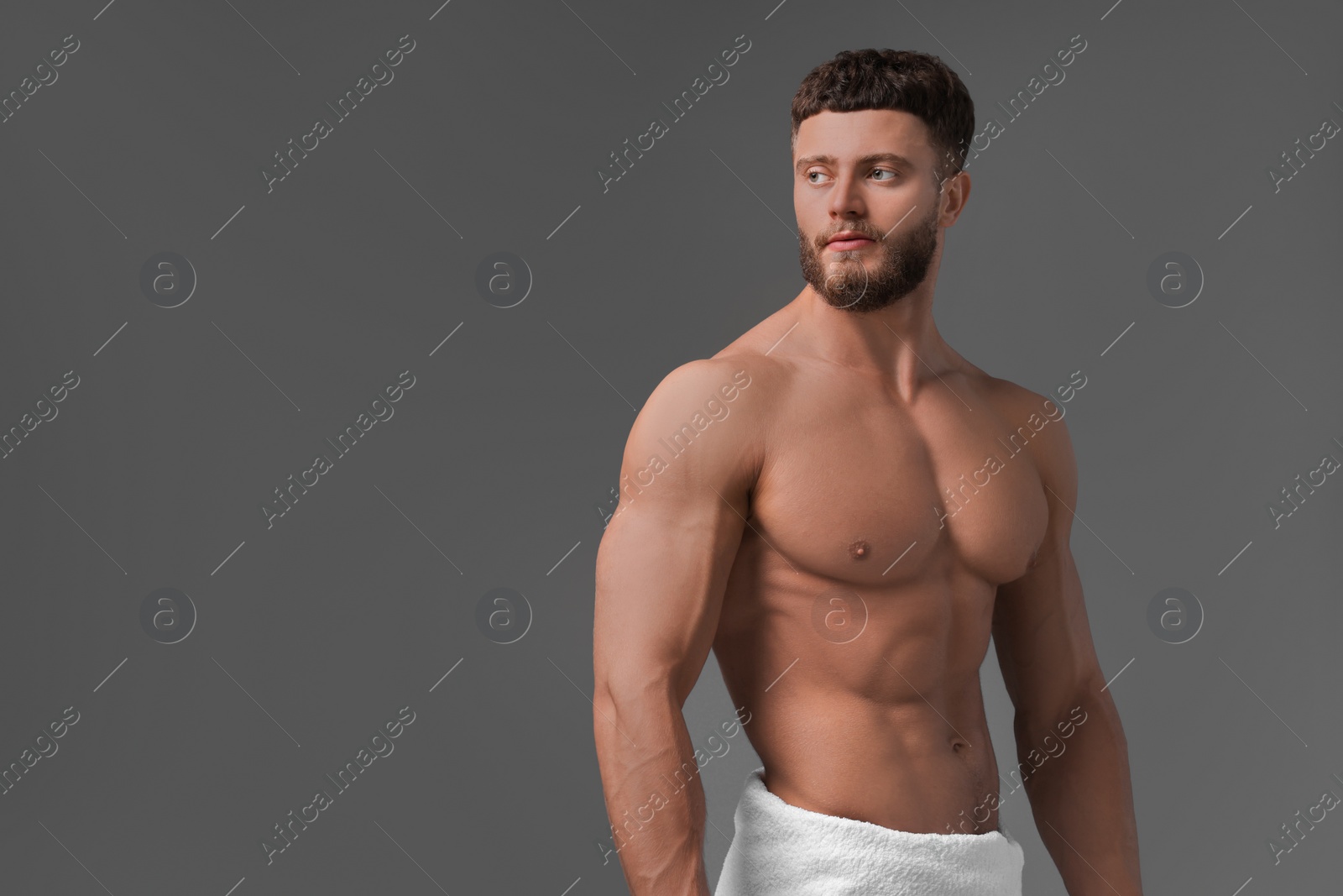 Photo of Handsome muscular man on grey background, space for text. Sexy body