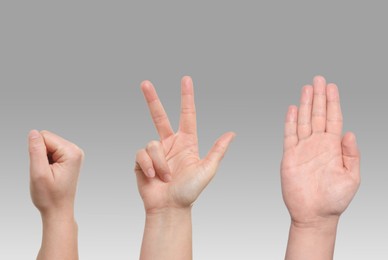 Image of People playing rock, paper and scissors on grey background, closeup