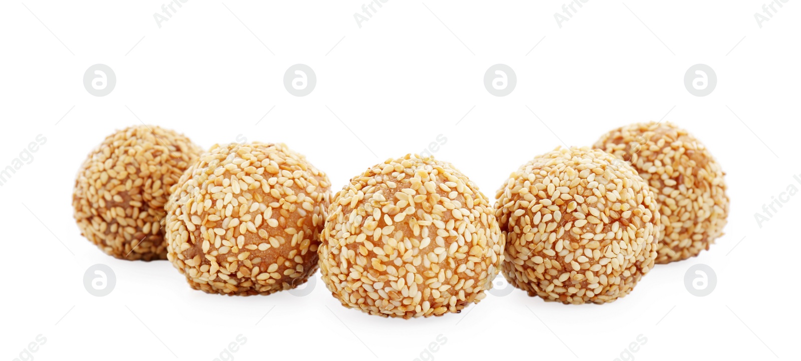 Photo of Many delicious sesame balls on white background