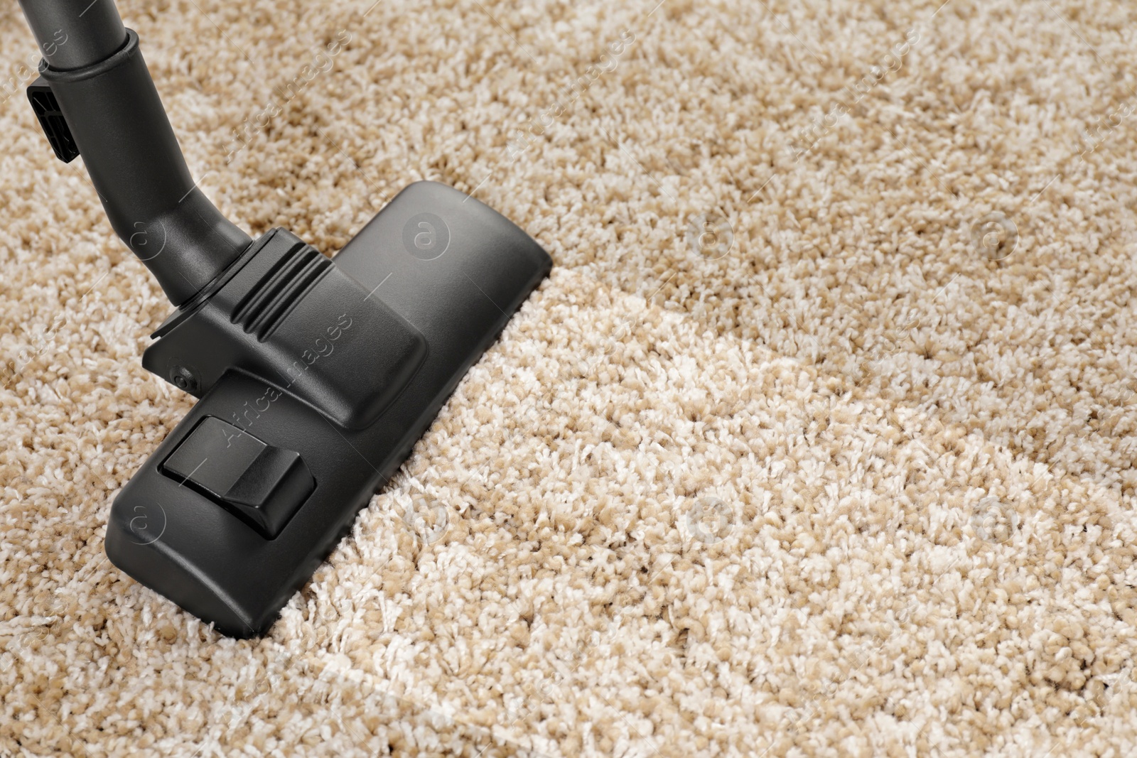 Image of Hoovering carpet with vacuum cleaner, closeup and space for text. Clean trace on dirty surface