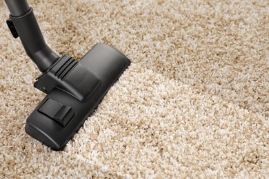 Image of Hoovering carpet with vacuum cleaner, closeup and space for text. Clean trace on dirty surface