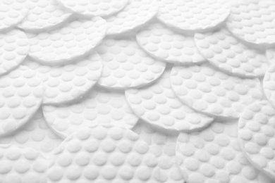 Many cotton pads as background, closeup view