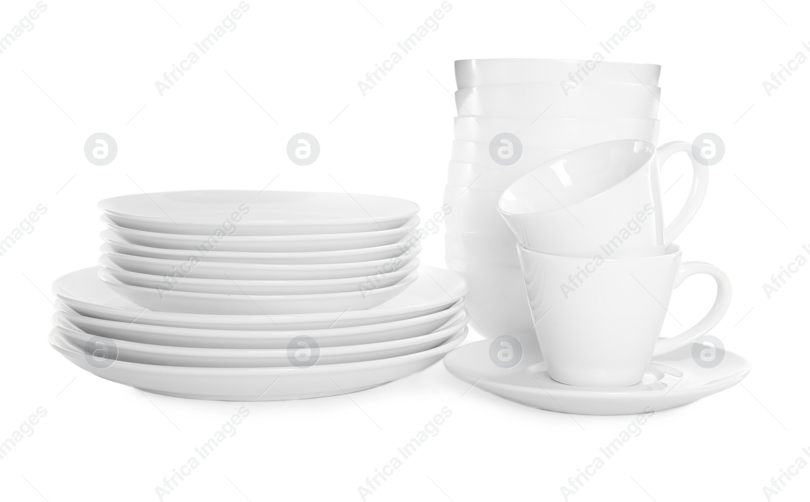 Photo of Stacked plates and cups on white background