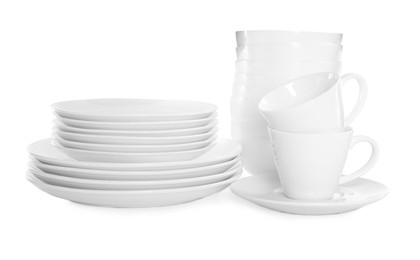 Photo of Stacked plates and cups on white background