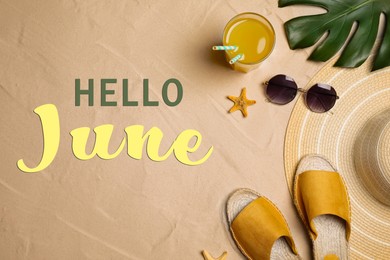 Hello June. Beach accessories on sand, flat lay