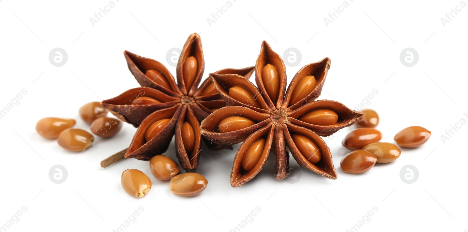 Photo of Dry anise stars with seeds on white background