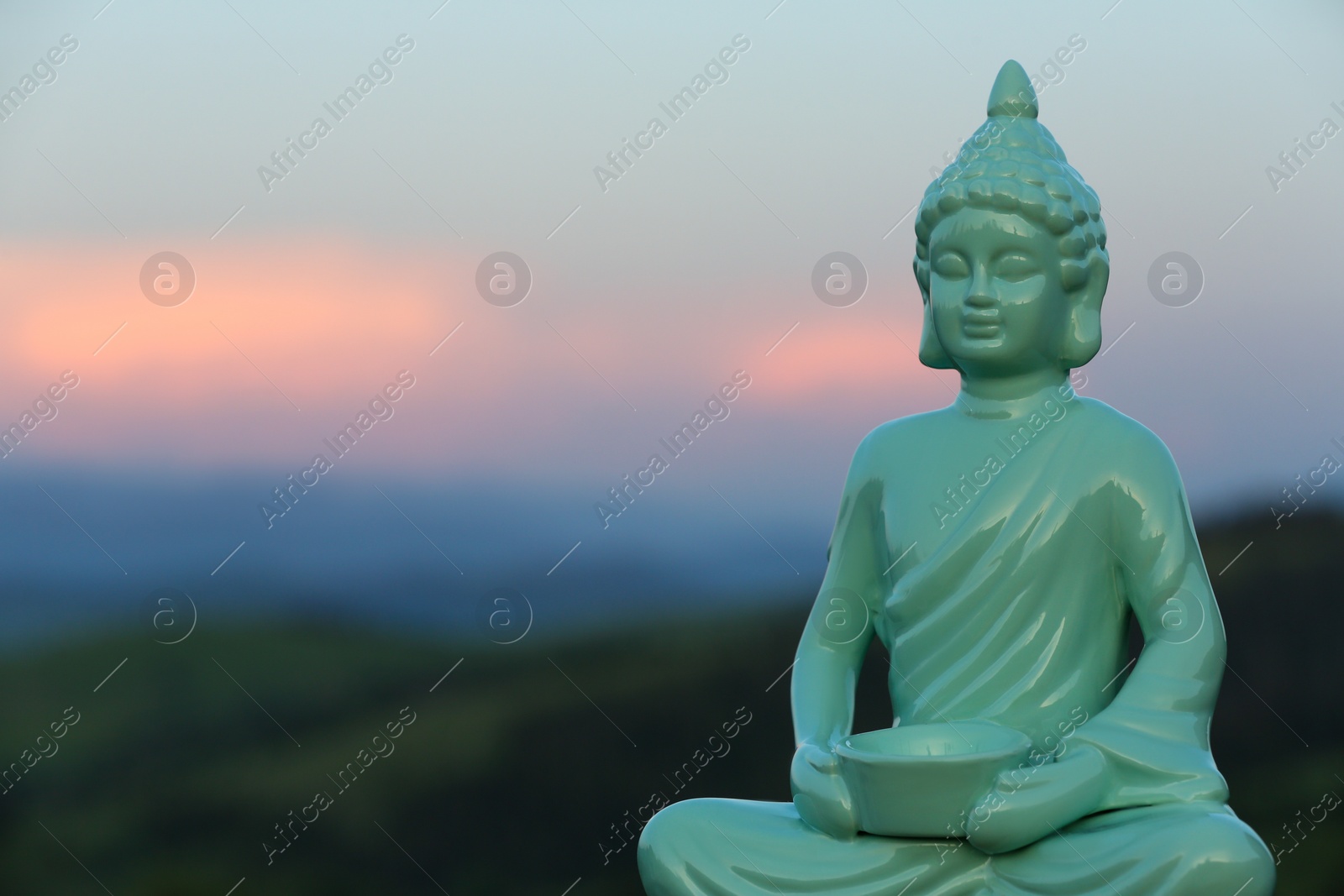 Photo of Decorative Buddha statue in mountains. Space for text