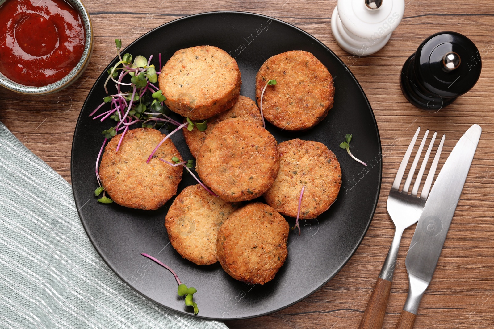 Photo of Delicious vegan cutlets served on wooden table, flat lay